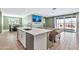 Modern kitchen with white cabinets, island, and stainless steel appliances at 5932 S 26Th Ave, Phoenix, AZ 85041