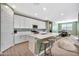 Open concept kitchen boasting white cabinets and a large island at 5932 S 26Th Ave, Phoenix, AZ 85041