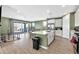 Open concept kitchen with island and stainless steel appliances at 5932 S 26Th Ave, Phoenix, AZ 85041
