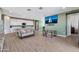 Open living space showcasing a large TV and access to the kitchen at 5932 S 26Th Ave, Phoenix, AZ 85041