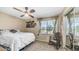 Comfortable bedroom with ceiling fan, bright window with blinds, rocking chair, and mirrored closet at 6178 W Quail Ave, Glendale, AZ 85308