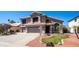 Two-story home featuring a three-car garage, a tile roof and desert landscaping at 6178 W Quail Ave, Glendale, AZ 85308