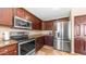 Modern kitchen with stainless steel appliances, custom cabinets, and granite countertops at 6178 W Quail Ave, Glendale, AZ 85308