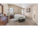 Serene main bedroom featuring arched windows, plush carpet, and ample space for a relaxing retreat at 6178 W Quail Ave, Glendale, AZ 85308