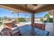 Relaxing covered patio with an outdoor dining area overlooking the pool and golf course at 6178 W Quail Ave, Glendale, AZ 85308