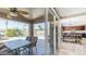 Covered patio with outdoor seating overlooking a sparkling pool and lush landscaping, seamlessly connected to the indoor kitchen at 6178 W Quail Ave, Glendale, AZ 85308