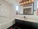 Clean bathroom with dark vanity, updated sink, and a tub at 652 S Ellsworth Rd # 41, Mesa, AZ 85208