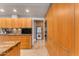 Modern kitchen with wood cabinets, granite counters, and stainless steel appliances at 7117 E Rancho Vista Dr # 3006, Scottsdale, AZ 85251