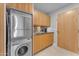 Laundry room with stacked washer and dryer, and wood cabinets at 7117 E Rancho Vista Dr # 3006, Scottsdale, AZ 85251