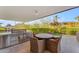 Patio with built-in grill, dining table and seating at 7117 E Rancho Vista Dr # 3006, Scottsdale, AZ 85251