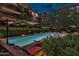 Evening view of community pool with lounge chairs at 7117 E Rancho Vista Dr # 3006, Scottsdale, AZ 85251