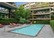 Community pool with lounge chairs and lush landscaping at 7117 E Rancho Vista Dr # 3006, Scottsdale, AZ 85251