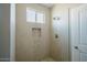 Shower with tiled walls and a built-in niche at 8519 W Teresita Dr, Arizona City, AZ 85123