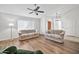 Living room with light wood floors and two sofas at 8832 W Bloomfield Rd, Peoria, AZ 85381