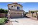 Two-story house with a two-car garage and landscaped front yard at 9011 W Harmony Ln, Peoria, AZ 85382