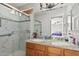 Bathroom boasts double vanity, granite countertop and walk-in shower at 9041 W Virginia Ave, Phoenix, AZ 85037