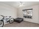 Bedroom with a mountain bike, ottoman, and large window at 9041 W Virginia Ave, Phoenix, AZ 85037