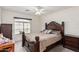 Bedroom with large bed, decorative pillows, and ceiling fan at 9041 W Virginia Ave, Phoenix, AZ 85037