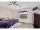 Spacious bedroom with large window, plush bedding, and dresser at 9041 W Virginia Ave, Phoenix, AZ 85037
