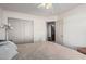 Bedroom with queen-size bed, ceiling fan, and closet at 9041 W Virginia Ave, Phoenix, AZ 85037
