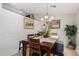 Bright dining room with a wood table and chandelier at 9041 W Virginia Ave, Phoenix, AZ 85037