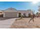 Single-story home with a two-car garage and well-maintained landscaping at 9041 W Virginia Ave, Phoenix, AZ 85037