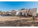 Single-story home with a two-car garage and mature trees at 9041 W Virginia Ave, Phoenix, AZ 85037