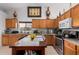 Well-equipped kitchen with wood cabinets and granite countertops at 9041 W Virginia Ave, Phoenix, AZ 85037