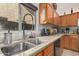 Kitchen with granite countertops, double sink, and wood cabinets at 9041 W Virginia Ave, Phoenix, AZ 85037