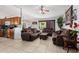 Open concept living and kitchen area with brown sofas at 9041 W Virginia Ave, Phoenix, AZ 85037