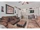 Spacious living room with brown sofas and a large TV at 9041 W Virginia Ave, Phoenix, AZ 85037