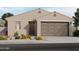 Single-story home with two-car garage and desert landscaping at 9102 N 174Th Ln, Waddell, AZ 85355