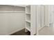 Large walk-in closet featuring built in shelving and chrome hanging rods at 9102 N 174Th Ln, Waddell, AZ 85355