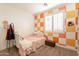 Bedroom with pink fluffy bed and orange wall at 9127 E Lynwood St, Mesa, AZ 85207