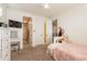 Bedroom with a pink fluffy bed and built in dresser at 9127 E Lynwood St, Mesa, AZ 85207