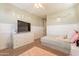 Bedroom with queen bed, TV, and carpeted floors at 9127 E Lynwood St, Mesa, AZ 85207