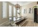Farmhouse-style dining area with wood table and bench, complemented by natural light at 9127 E Lynwood St, Mesa, AZ 85207