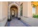 Elegant entryway with arched doorway and brick walkway at 9127 E Lynwood St, Mesa, AZ 85207