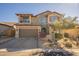 Two-story home with stone accents and a three-car garage at 9127 E Lynwood St, Mesa, AZ 85207