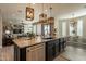 Large kitchen island with seating, granite countertops and stainless steel appliances at 9127 E Lynwood St, Mesa, AZ 85207