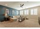Open loft with comfortable sectional sofa and large windows at 9127 E Lynwood St, Mesa, AZ 85207
