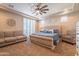 Large main bedroom with plush carpet, a king-size bed, and a ceiling fan at 9127 E Lynwood St, Mesa, AZ 85207