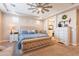 Comfortable main bedroom featuring a king bed, dresser, and ensuite bathroom access at 9127 E Lynwood St, Mesa, AZ 85207