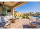 Covered patio with comfortable seating overlooking the pool and backyard at 9127 E Lynwood St, Mesa, AZ 85207