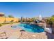 Spacious backyard oasis with a kidney shaped pool and a basketball hoop at 9127 E Lynwood St, Mesa, AZ 85207