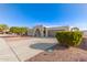 Landscaped front yard of a ranch-style home with a driveway at 9226 W Glen Oaks N Cir, Sun City, AZ 85351