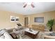 Virtually staged living room with comfortable seating and a large flat screen TV at 9607 N 41St Dr, Phoenix, AZ 85051