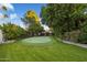 Landscaped backyard with putting green and mature trees at 10232 N 54Th Pl, Paradise Valley, AZ 85253
