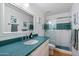 Updated bathroom with teal vanity, walk-in shower, and modern fixtures at 10232 N 54Th Pl, Paradise Valley, AZ 85253