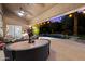 Inviting backyard oasis with a sparkling pool, patio furniture, and string lights at 10232 N 54Th Pl, Paradise Valley, AZ 85253